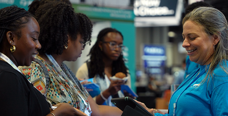 NCARB staff answers customer questions at the 2024 AIA conference in Washington, DC.
