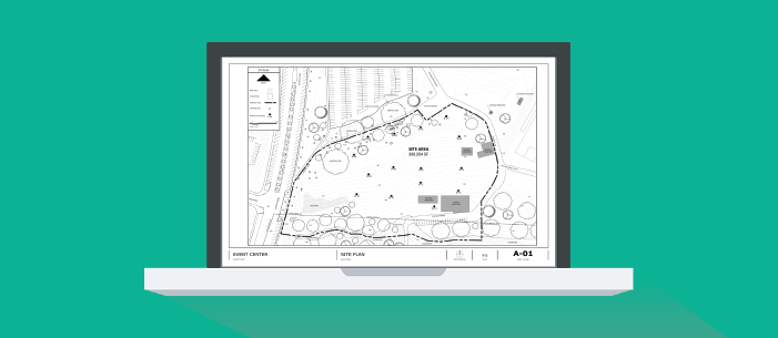Laptop screen on a green background. Screen features an image of a site plan. 