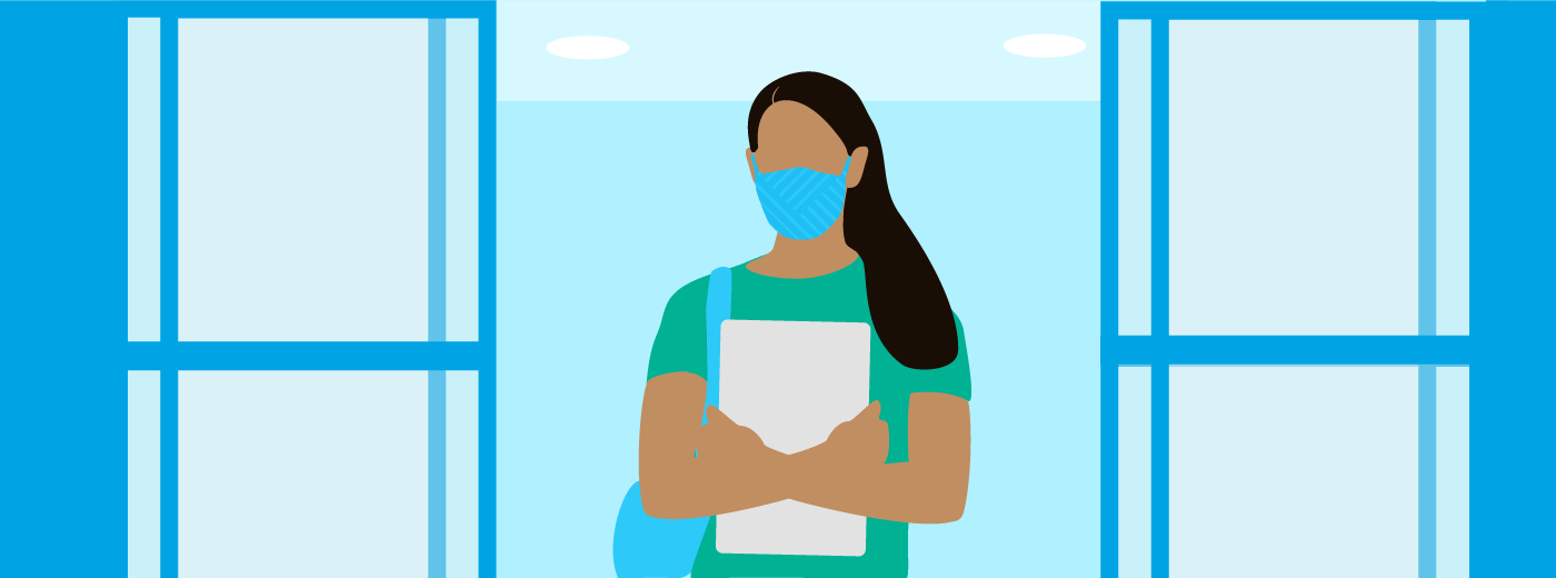 Woman with face covering walking into test center