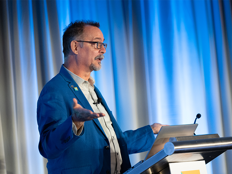 NCARB Vice President of Experience and Education Harry Falconer presenting at a podium while at a conference