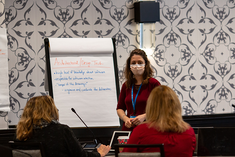 Volunteers collaborate during an in-person meeting. 