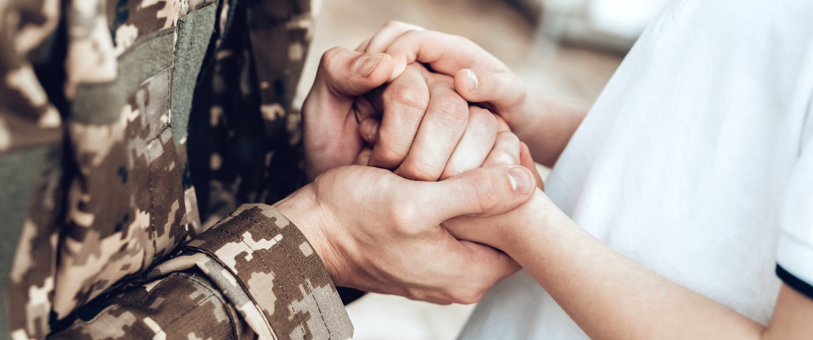 Photo of a veteran holding hands with a loved one.