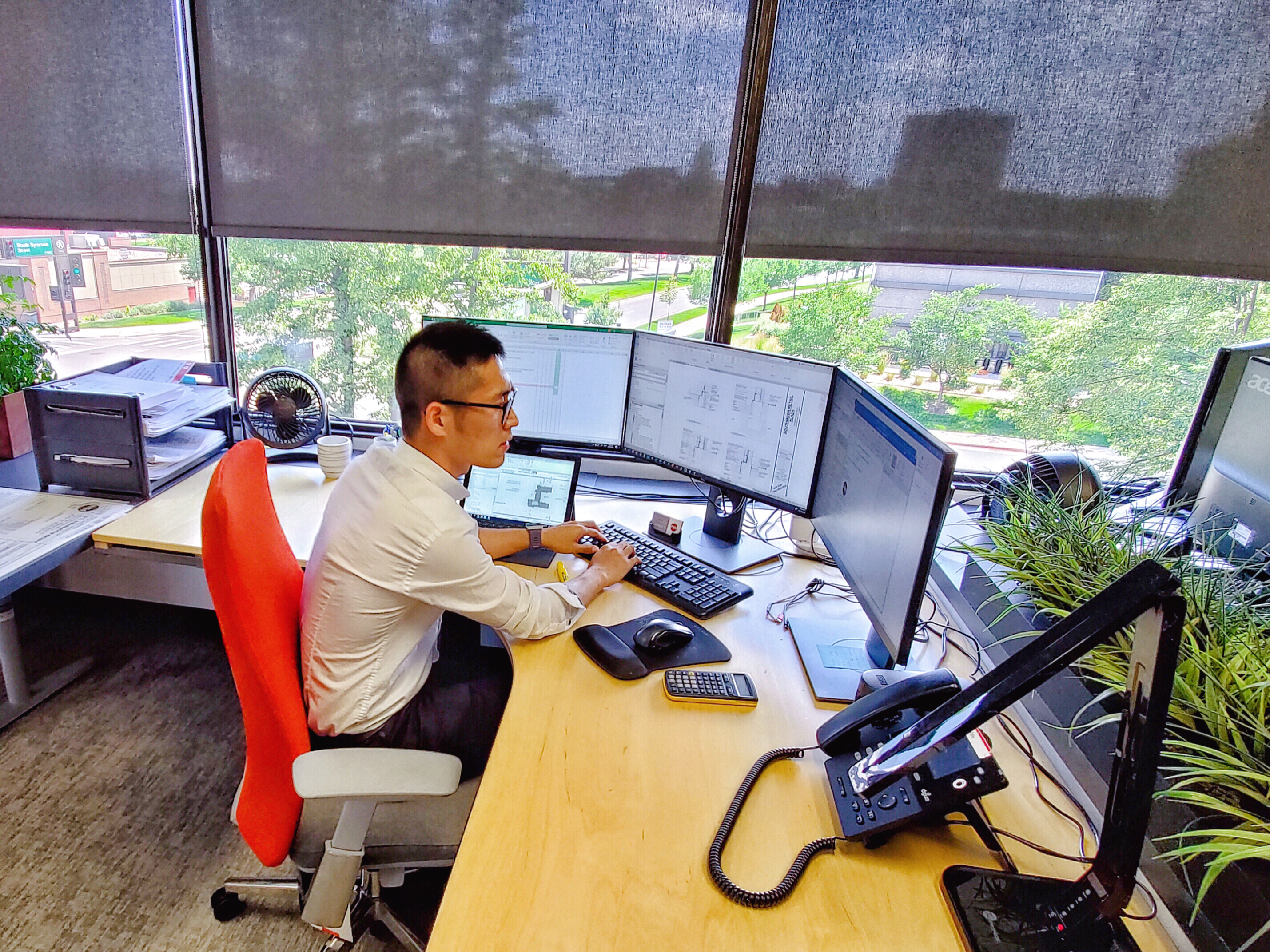 Photo of Alan Li working in his role at PWN Architects and Planners