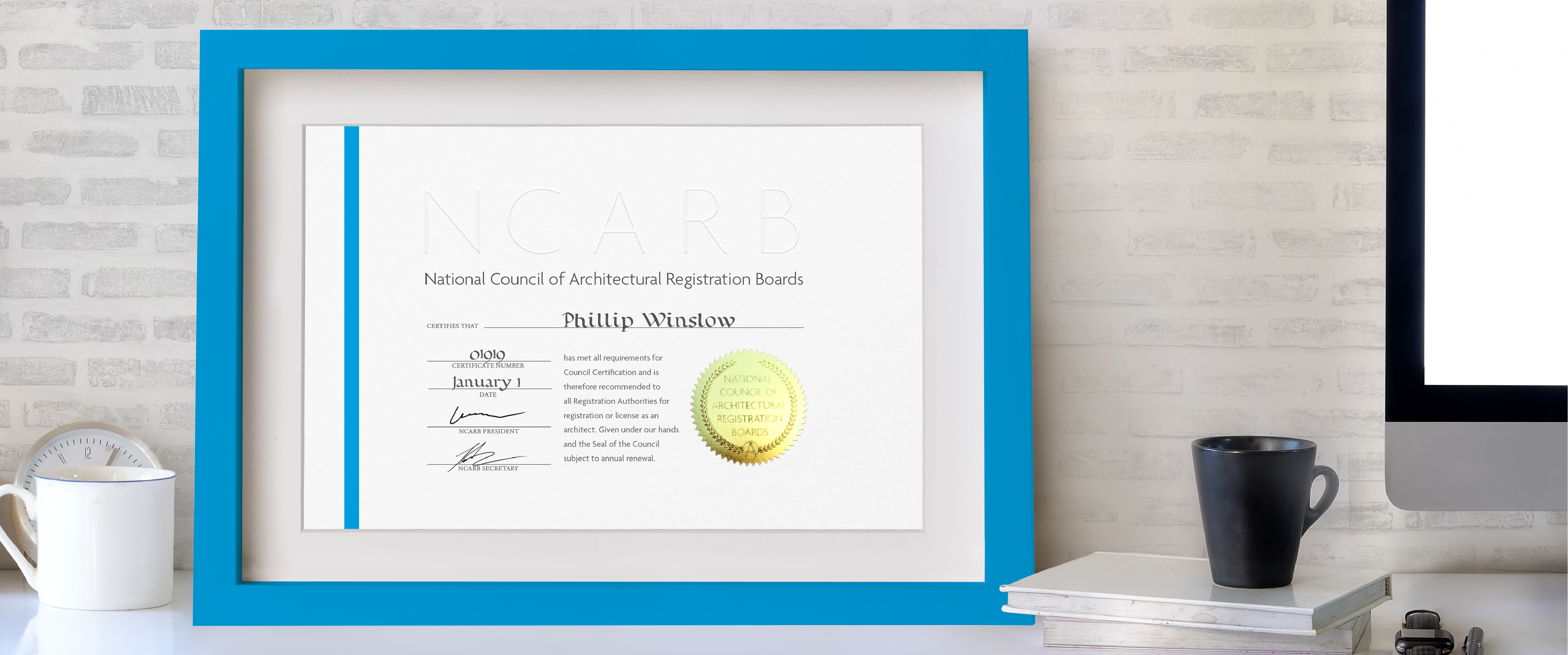 A framed NCARB Certificate sits on a desk.