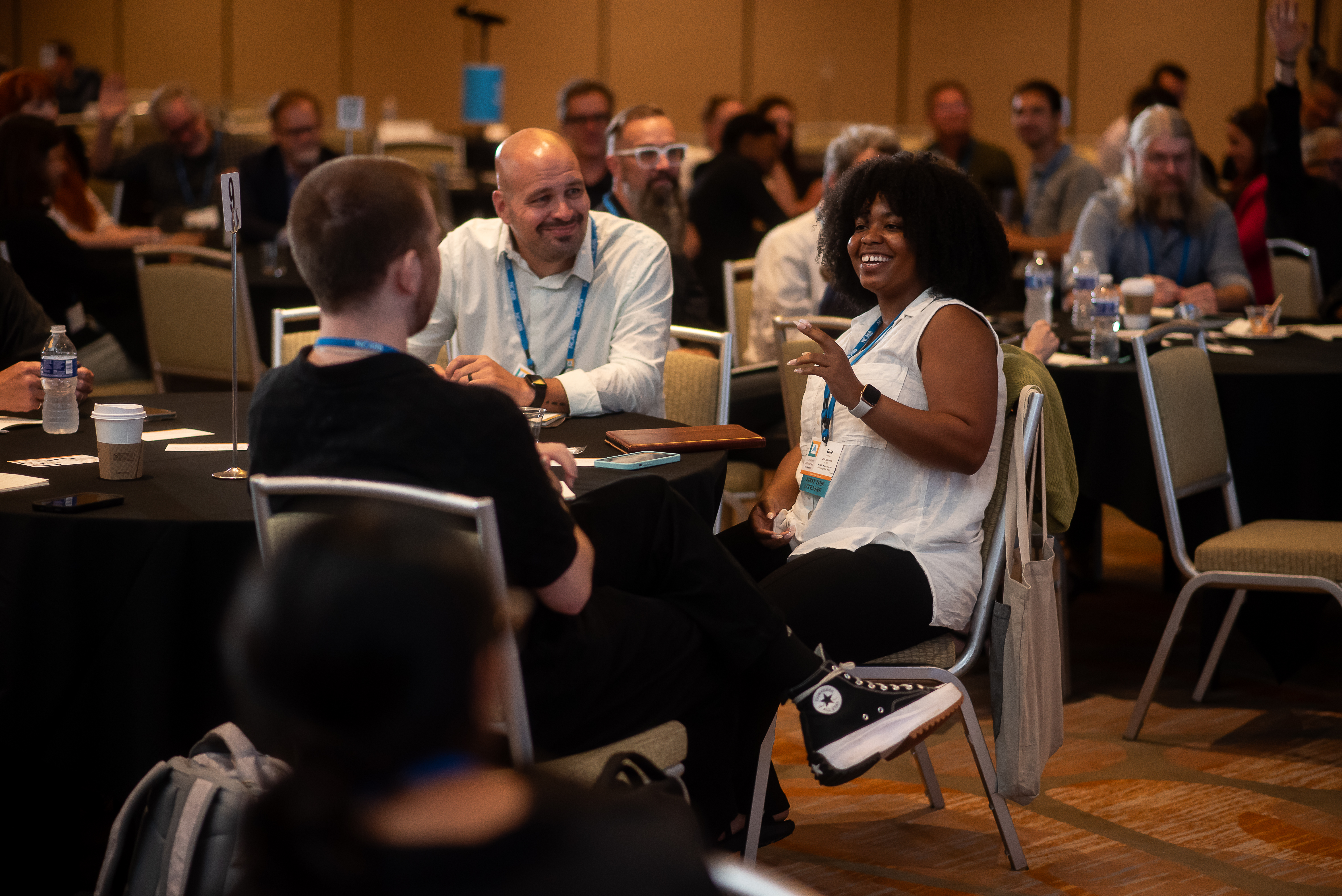 A group of conference attendees talking at a table.