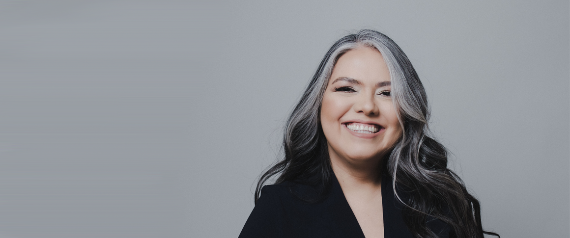 Patrica Rosales in front of a gray background.
