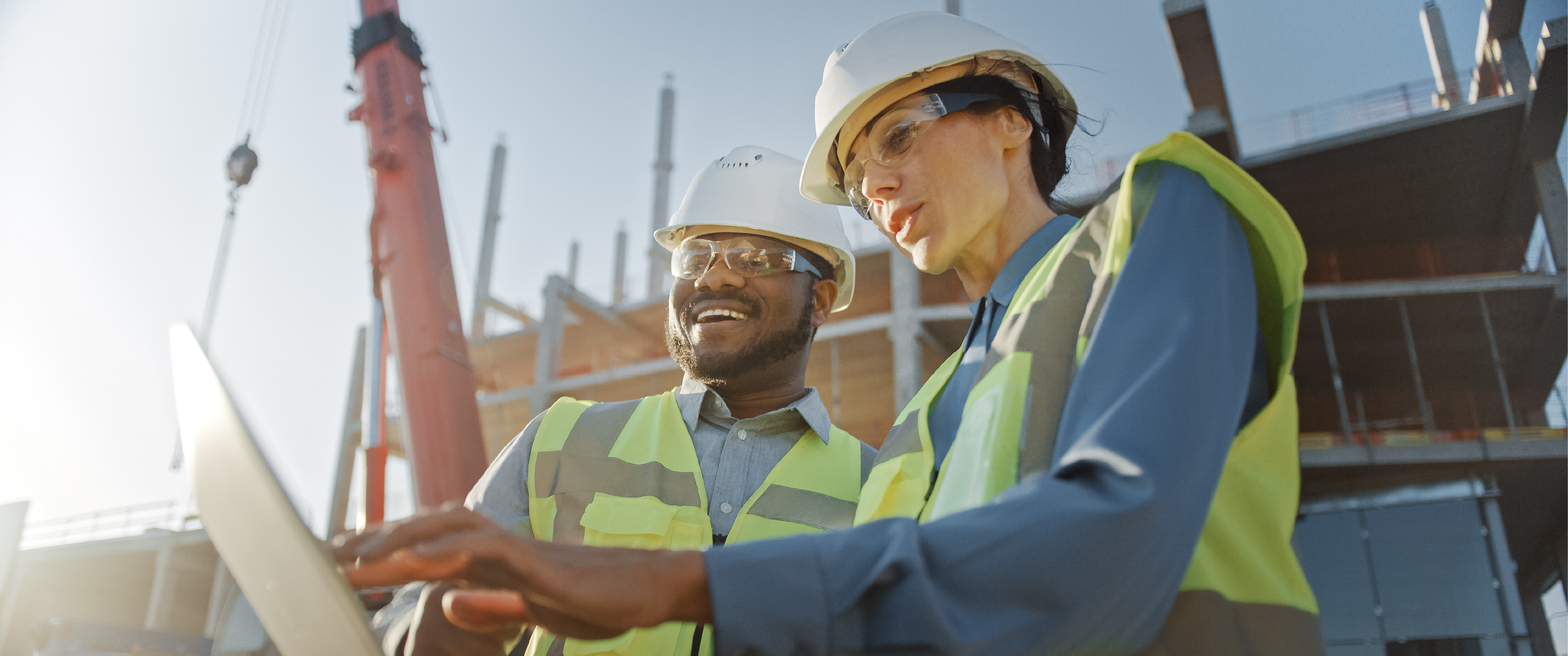 Two construction workers at a site. 