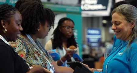 NCARB staff answers customer questions at the 2024 AIA conference in Washington, DC.