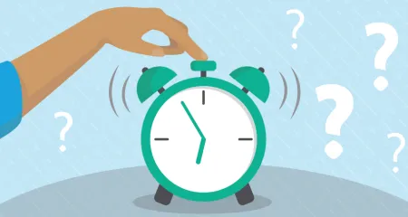 A person hits the top of an alarm clock to stop it. 