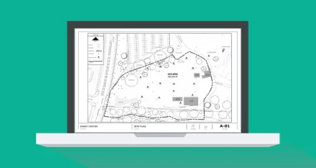 Laptop screen on a green background. Screen features an image of a site plan. 