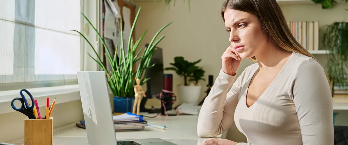 A candidate looks at their laptop, which does not have a 360-degree webcam.