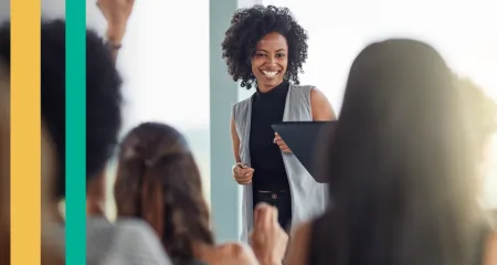 A woman smiles while talking with other employees at her firm.