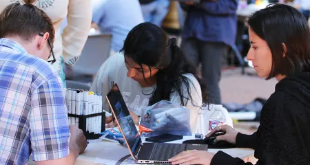 Photo of students working together at 2022 Interschool Student Design Competition.