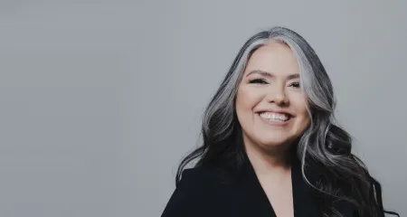 Patrica Rosales in front of a gray background.