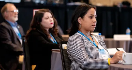 Three member board members watch a presentation during NCARB's 2021 Annual Business Meeting.