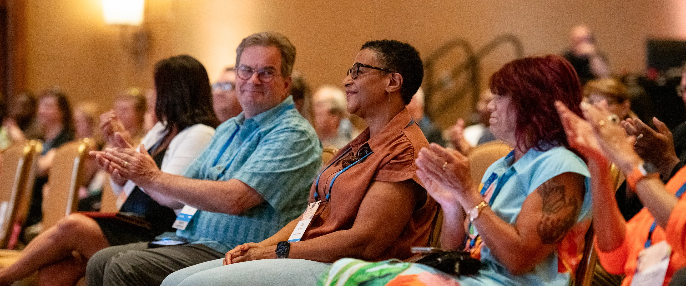 Attendees clap during a session at the Annual Business Meeting.