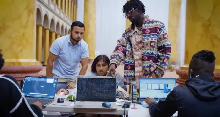 Architecture students talk and work together on a project.