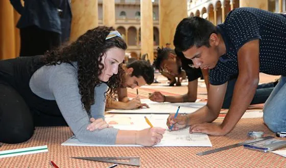 Students sketch together during a group project at their univeristy.