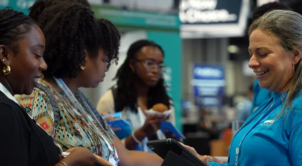 NCARB staff answers customer questions at the 2024 AIA conference in Washington, DC.