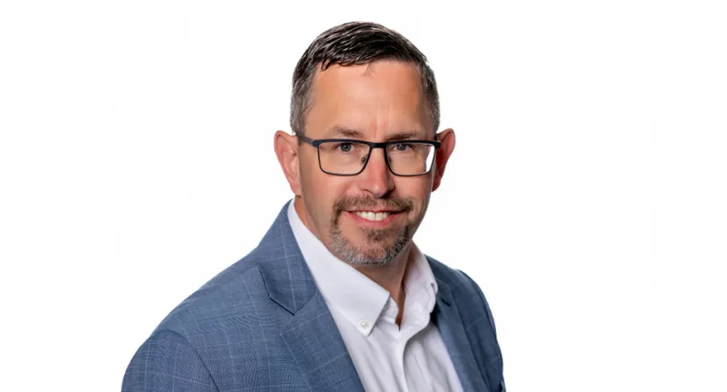 Headshot of James Devine in 2025. 