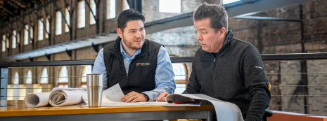 Andrew Tillman works with his supervisor at his firm, Zimmerman Architectural Studios.