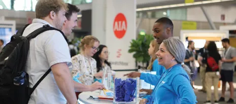 An NCARB staff member talks to customers at the 2026 AIA National Conference on Architecture & Design.