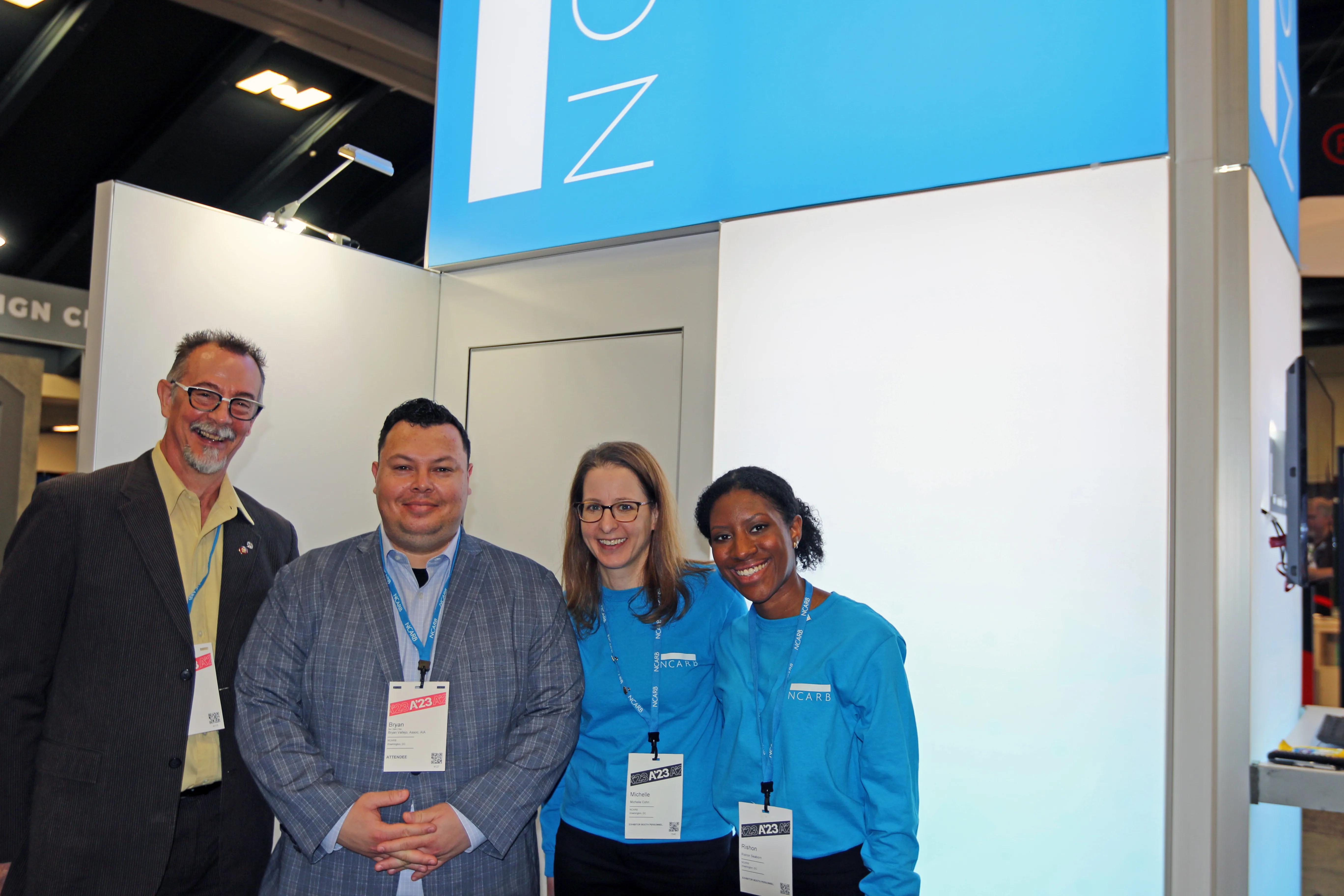 NCARB staff leaders smile in front of the A'23 booth.